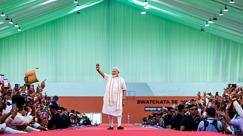 Prime Minister Narendra Modi waves to the gathering during the 'NaMo for Viksit Bharat' event, in Vadodara, Gujarat.