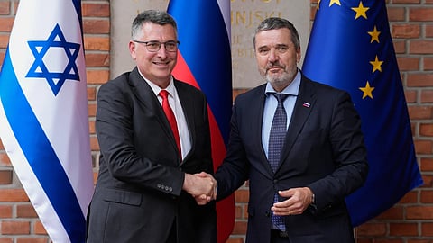 Israel's Foreign Minister Gideon Sa'ar, left, is welcomed by his Slovenian counterpart Tone Kajzer in Ljubljana, Slovenia