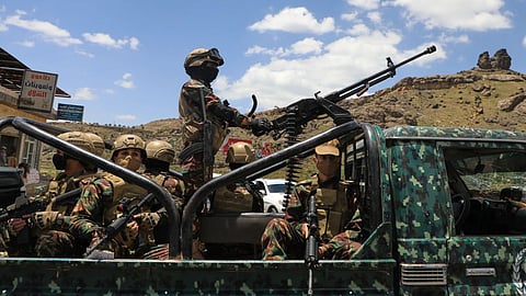 Houthi fighters escort a convoy carrying prisoners freed in Mokha through the Bani Matar district on its way to Sanaa, Yemen, following the Houthi takeover of the southern Red Sea port city.