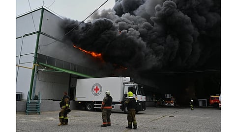 Firefighters put out a fire at warehouse stores after a Russian air attack in Odesa, Ukraine, Sunday, Sept. 13, 2026