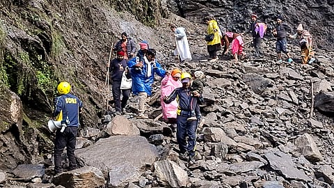 SDRF personnel evacuate stranded pilgrims after debris and stones temporarily closed the Kedarnath Yatra trekking route near Chirbasa helipad, in Rudraprayag, Uttarakhand, Monday, Sept. 14, 2026