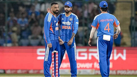 India's Varun Chakravarthy, left, celebrates after the wicket of Afghanistan's Darwish Rasooli during the first T20I cricket match between India and Afghanistan, in New Delhi.