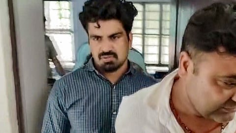 Police personnel escort Kalyan Bainsla, accused of chasing and ramming his car into woman biker Shivani Chauhan (Sia) on Gurugram's Golf Course Road, following his arrest in Dausa district, Rajasthan