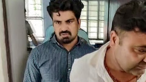 Police personnel escort Kalyan Bainsla, accused of chasing and ramming his car into woman biker Shivani Chauhan (Sia) on Gurugram's Golf Course Road, following his arrest in Dausa district, Rajasthan