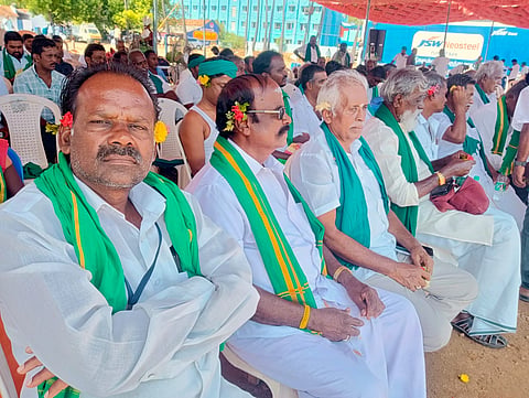 Farmers with flowers on their ears protest in Tiruchy on Friday 