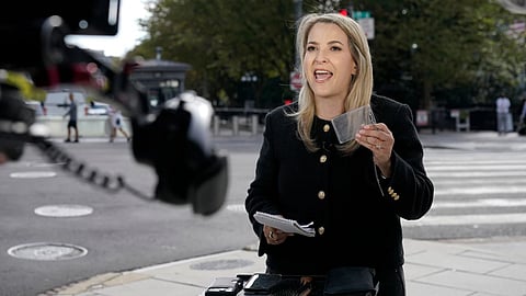 CNN Senior White House Reporter Betsy Klein, holding up an empty credential holder, reports near the White House complex after having her credential confiscated following President Donald Trump's ban on CNN, MS NOW and Politico, in Washington.