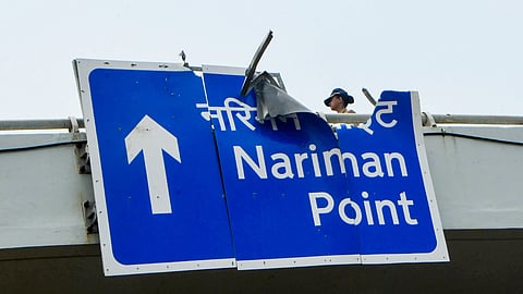 A police official stands near a damaged overhead road sign after a BMW car crashed on the Coastal Road while moving at a high speed from Marine Drive towards Haji Ali, in Mumbai, Maharashtra, Sunday, Sept. 20, 2026