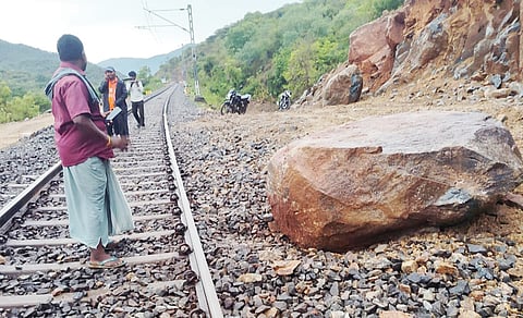 A boulder rolled down a rain-soaked hilly terrain and crashed onto a moving express train near Dharmapuri on Sunday.