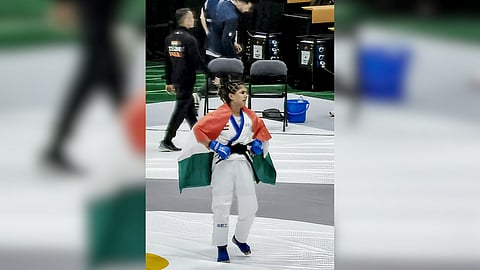 India's Suchika Tariyal reacts after Singapore's Hui Hoon Teo, unseen, was awarded the semifinal win on account of her lower weight after the two fighters drew the gruelling bout in the women's traditional 60kg mixed martial arts event at the Asian Games in Nagoya, Japan.