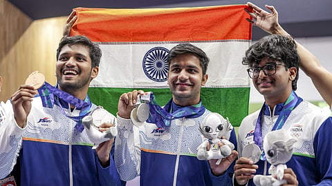 India's Himanshu Dhillon, centre, Rudrankksh Patil, left, and Parth Rakesh Mane pose for photographs after wiining silver medal in the 10 meter rifle men team event in the ongoing 20th Asian Games 2026, in Nagoya, Japan.