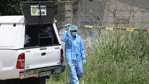 Forensic personnel is seen at a scene where bodies of the victims of a mass shooting where found at a bar near Pretoria, South Africa