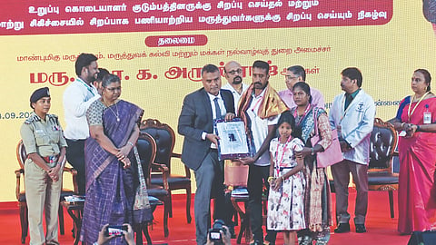Health Secretary Darez Ahamed honouring a family at an event on Wednesday