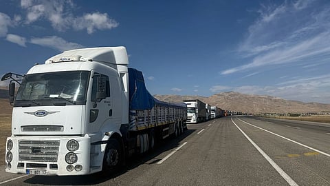 Trucks queue on the road leading to the Gurbulak border crossing on the Turkish-Iranian border in Agri province, eastern Turkey.