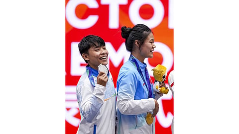 India's silver medallist Roshibina Devi Naorem, left, and China's gold medallist Zhang Xiaoyu during the medal ceremony after the Women's 60kg Wushu final match during the 20th Asian Games, in Nagoya, Japan