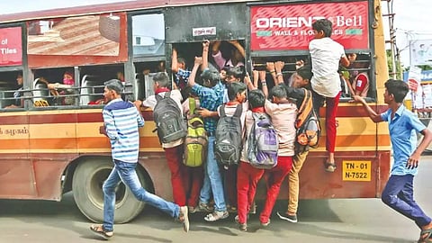 Youngsters footboarding on an MTC bus