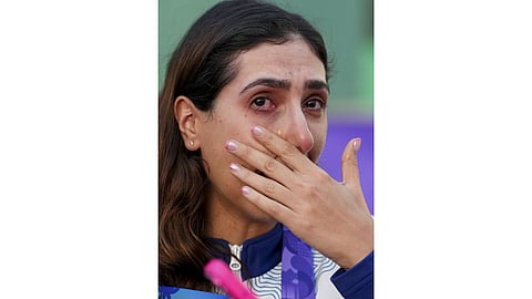 India's Parinaaz Dhaliwal gets emotional after winning bronze in the Skeet Women Team Final event, during the 20th Asian Games, in Nagoya, Japan.