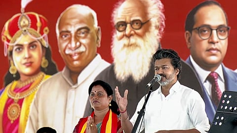 Tamil Nadu Chief Minister and TVK President C Joseph Vijay speaks as party candidate K. Maragatham Kumaravel, left, looks on during a campaign rally for the Madurantakam Assembly constituency by-election, in Chengalpattu district