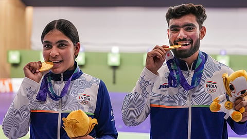 India's Suruchi Singh, right, and Kamaljeet hold the national tri-colour flag as they celebrate after winning Gold medal in the 10 meter air pistol mixed team final in the ongoing Asian Games 2026, in Nagoya, Japan, Friday, Sept. 25, 2026