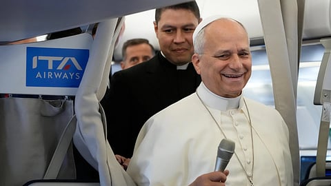 Pope Leo XIV talks to journalists aboard the papal flight from Rome to Paris