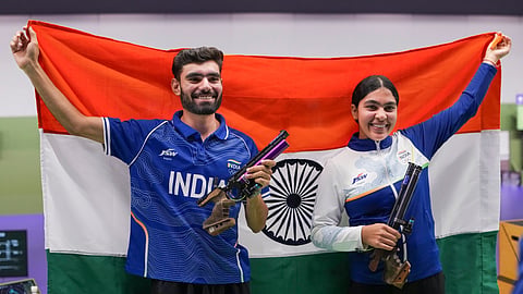 India's Suruchi Singh, right, and Kamaljeet hold the national tri-colour flag as they celebrate after winning Gold medal in the 10 meter air pistol mixed team final in the ongoing Asian Games 2026, in Nagoya, Japan, Friday, Sept. 25, 2026