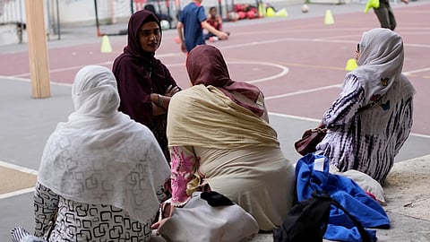 Jannatur Nayeem, 33, an Italian citizen of Bangladeshi origin, top left, chats with other mothers as they wait for a sports lesson to end at a school in downtown Rome
