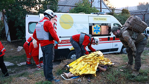  Medics inspect a body of a woman killed in a Russian strike on residential neighbourhood on Zaporizhzhia, Ukraine, on Saturday, Sept.26, 2026.