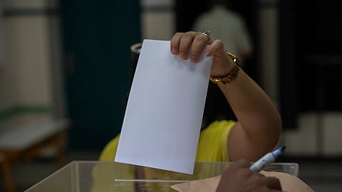 A woman casts her vote inside a polling station during the legislative elections in Rabat, Morocco