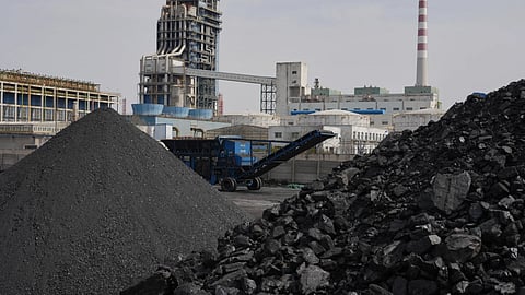 Piles of coal sit near a chemical plant in Datong, China