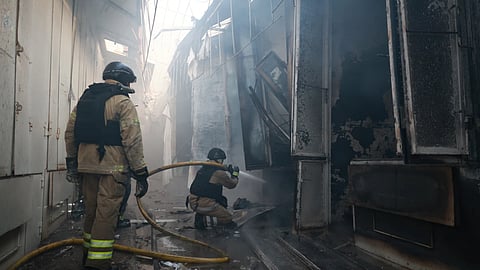 Rescue workers put-out a fire of the central market damaged in a Russian strike on Zaporizhzhia, Ukraine