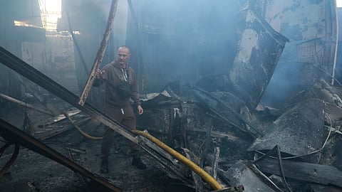 A man walks at the central market damaged in a Russian strike on Zaporizhzhia, Ukraine.