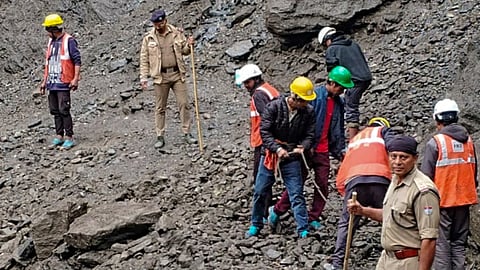 Rescue and disaster management personnel clear debris and boulders to restore the damaged Kedarnath pedestrian trek route following a landslide near the Chirbasa helipad, in Rudraprayag district, Uttarakhand