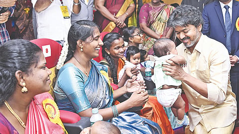 Chief Minister C Joseph Vijay with a baby at the scheme’s launch at Rajaji Hospital in Madurai on Monday