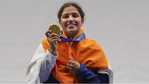 India's Neeru Dhanda looks at her gold medal during the victory ceremony for the women's trap shooting individual event at the 20th Asian Games 2026, in Nagoya.