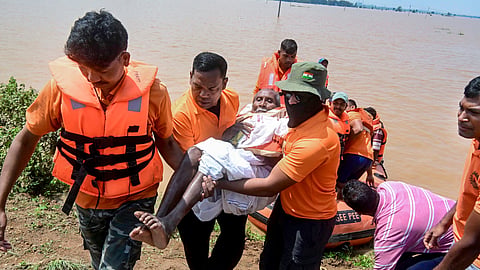 SDRF personnel conduct a rescue operation at a flood-affected area of Surali village in Koraput, Odisha