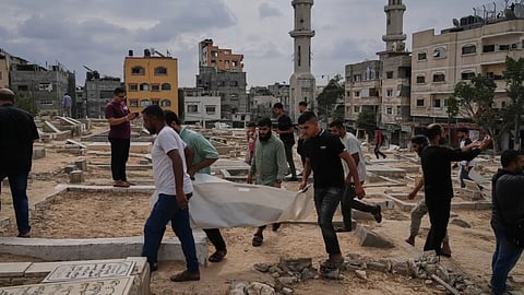 Mourners carry the remains of Palestinians killed in Israeli strikes during the war with Hamas after they were recovered from the rubble, during their funeral in Nuseirat, Gaza Strip.