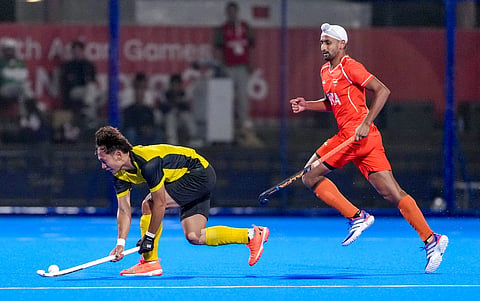 India's player, orange, and Malaysia's player comepete during the men's Hockey finals gold medal match between Malaysia and India in the ongoing 20th Asian Games, in Gifu, Japan, Saturday, Oct. 3, 2026