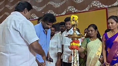 Screengrab of TVK MLA Navalpattu S Viji knocking the candle out of the hands of Congress MP M Christopher Tilak at an event in Tiruchy on Monday