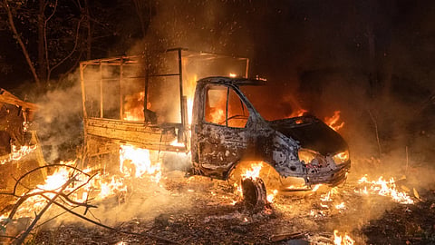 A car burns after a Russian drone strike on a residential neighborhood in Kharkiv, Ukraine