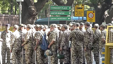 Security personnel stand guard near Transport Bhawan ahead of a proposed march by INDIA bloc leaders towards the Election Commission of India demanding the resignation of Chief Election Commissioner Gyanesh Kumar, in New Delhi.