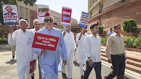 Trinamool Congress (TMC) leaders Derek O'Brien and Abhishek Banerjee along with party MPs march from Parliament towards the Election Commission of India office, holding placards to demand the resignation of Chief Election Commissioner Gyanesh Kumar, in New Delhi.