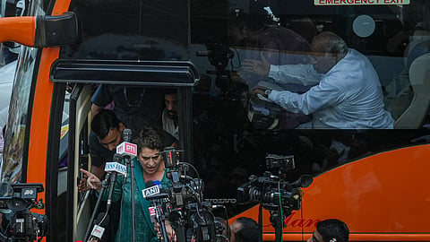 Congress leader Priyanka Gandhi Vadra speaks to the media aboard a bus carrying INDIA bloc MPs en route to Jantar Mantar for a sit-in protest against Chief Election Commissioner (CEC) Gyanesh Kumar, in New Delhi, Wednesday, Oct. 7, 2026. Congress President Mallikarjun Kharge is also seen
