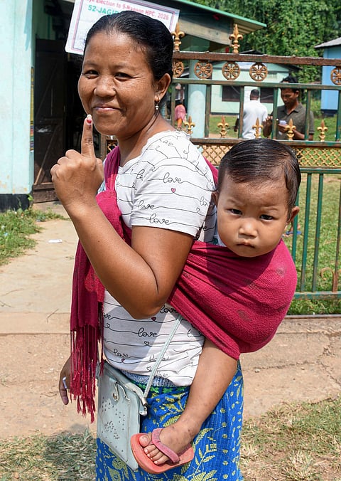 A woman shows her ink-marked finger after casting a vote in the Nagaon Lok Sabha by-polls, in Morigaon, Tuesday, Oct. 6, 2026