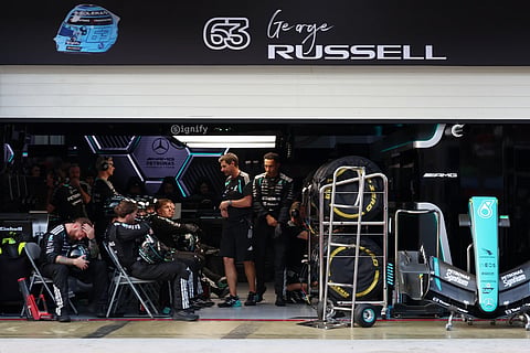Mercedes crew members for driver George Russell of Britain react inside the garage during the Bahrain Grand Prix in Sepang, Malaysia, Sunday, Oct. 4, 2026.