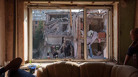 Locals and rescuers clear the rubble of a residential building destroyed in a Russian missile strike on Pryluky, Ukraine, Wednesday, Oct. 7, 2026.