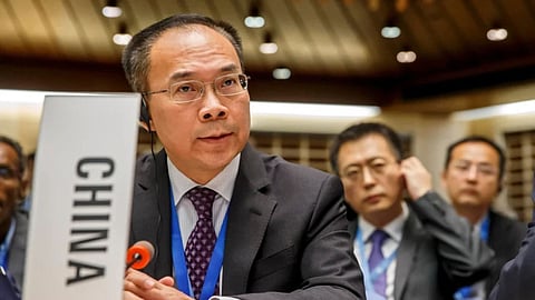 China’s Ambassador Song Li asks the floor after moving a placard identifying his country, during the 146th session of the World Health Organization Executive Board, at the World Health Organization (WHO) headquarters in Geneva, Switzerland.
