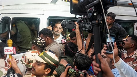 Congress leader Amarinder Singh Raja Warring, NSUI President Vinod Jakhar and others alight atop a bus carrying party leader Rahul Gandhi after his detention during a sit-in protest against Chief Election Commissioner (CEC) Gyanesh Kumar, in New Delhi