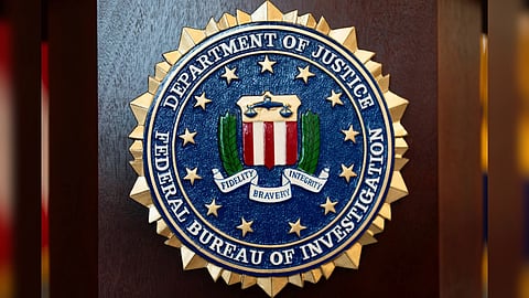 An FBI seal is displayed on a podium before a news conference at the field office in Portland, Ore.