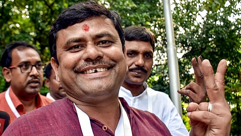 BJP candidate from Rejinagar Assembly Sakharav Sarker shows victory sign after the party leads as the counting of votes is underway for the assembly by-elections, in Rejinagar