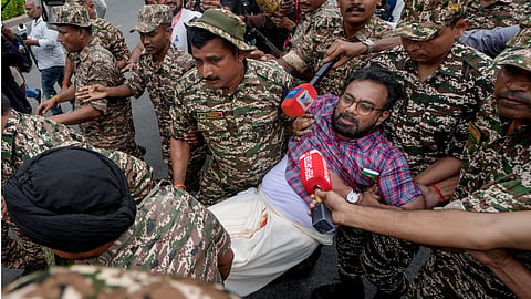 Police personnel detain CPI (M) MP John Brittas amid continued demonstration calls by the Cockroach Janta Party (CJP) demanding the resignation of Chief Election Commissioner (CEC) Gyanesh Kumar, in Connaught Place area, New Delhi.