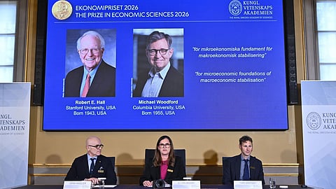 Portraits of Robert E. Hall and Michael Woodford are shown on the screen as they are announced as the laureates of the Sveriges Riksbank Prize in Economic Sciences in Memory of Alfred Nobel at the Royal Swedish Academy of Sciences in Stockholm, Sweden.